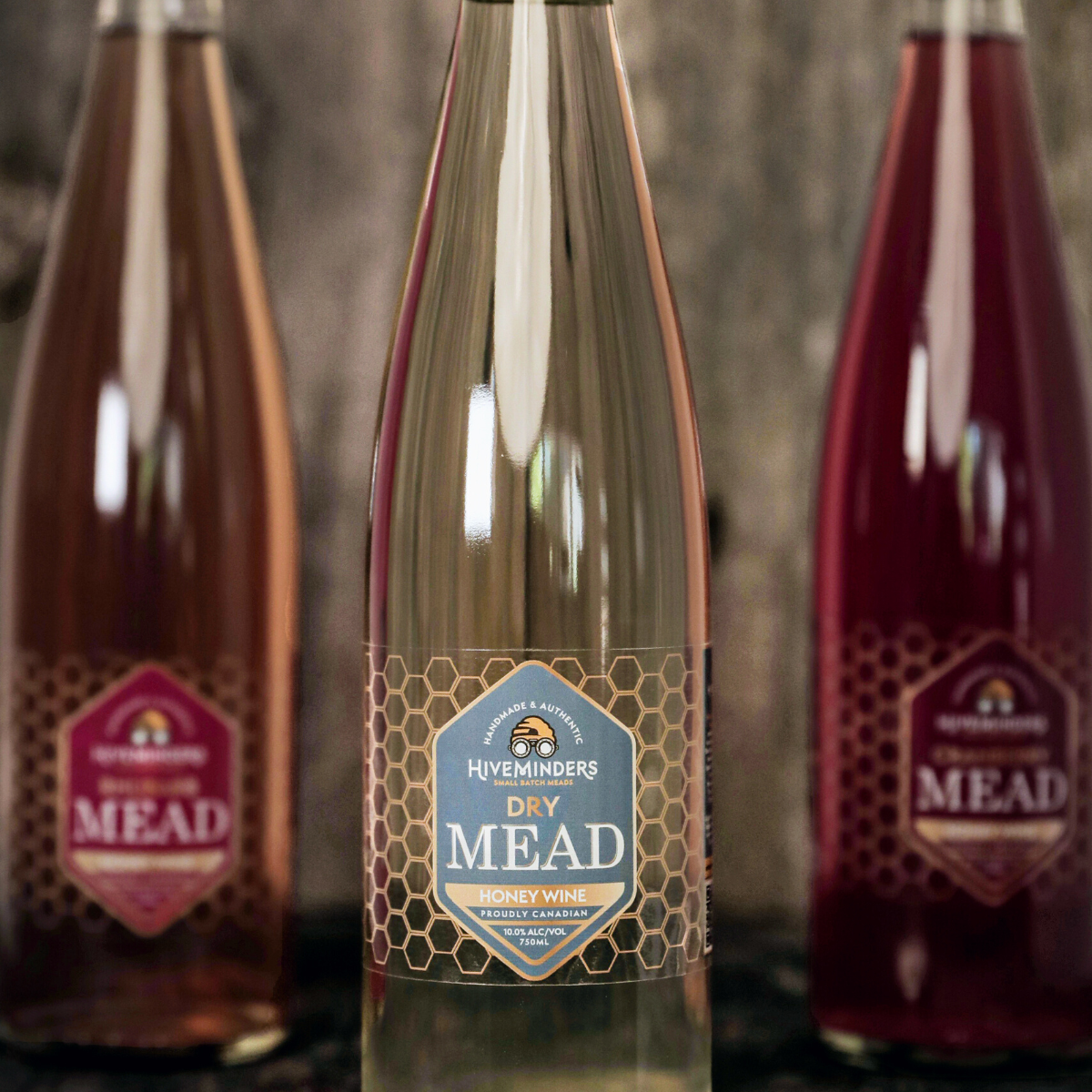 Bottle of Dry mead in the front, with two other bottles of Mead in the background.