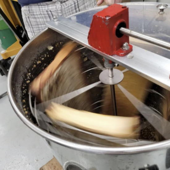 Honey frames spinning in a manual honey extractor. 
