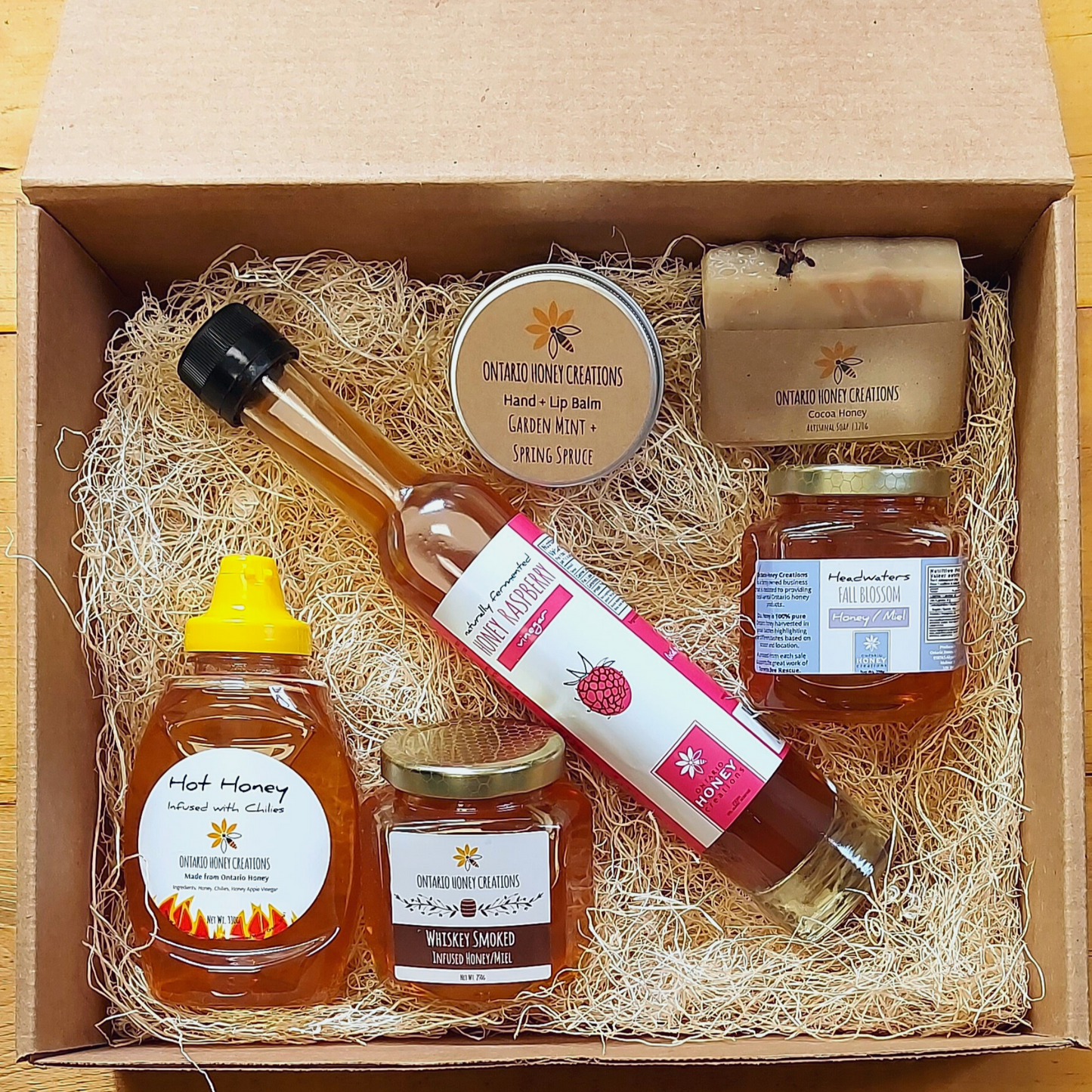 Gift box with Honey Raspberry Vinegar, Hot Honey, Whiskey Smoked Honey, Hand & Lip Balm, and Headwaters Fall Blossom Honey.