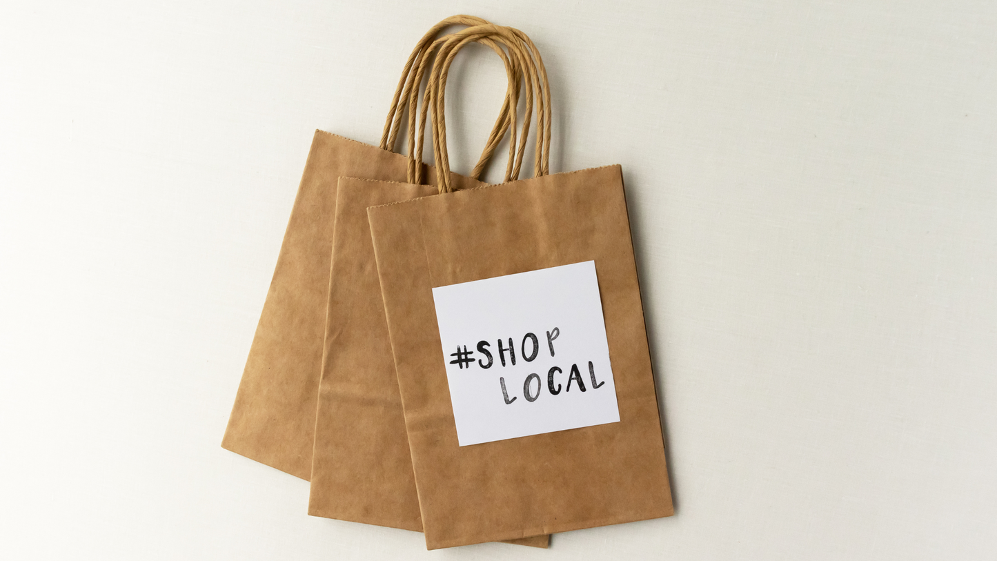 Brown paper bags that say "Shop Local"