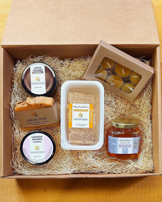 Gift box with Honey Comb, Cocoa and Lavender Creamed Honey, Beeswax Tealight Candles, and Headwaters Fall Blossom Honey.